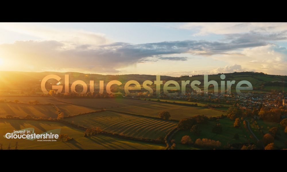 A sunset over open fields with the word Gloucestershire overlaid